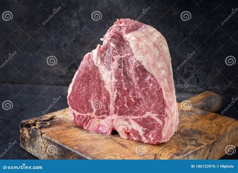 Traditional Raw Dry Aged Wagyu Porterhouse Steak On An Old Rustic