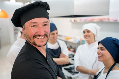 Team Of Chef Sous Chefs And Cooking Assistants At The Kitchen Talking