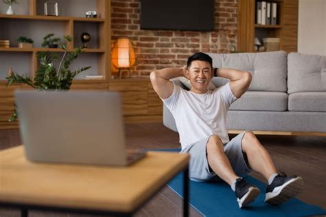 Premium Photo Smiling Asian Mature Man Working On Abs Watching