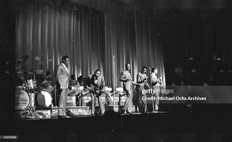 James Brown's band performs onstage at the Apollo Theatre in 1964 in ...