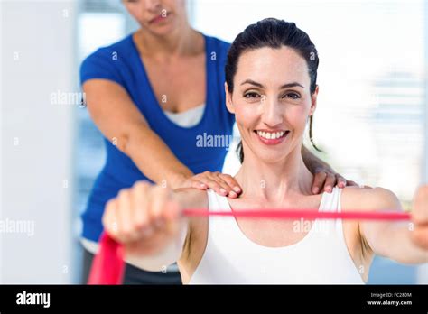 Brunette Stretching With Her Coach And Pink Cloth Stock Photo Alamy
