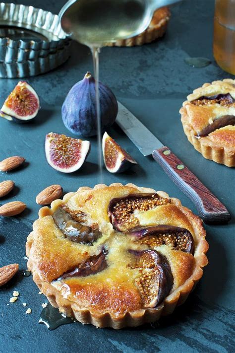 An Individual Fig And Almond Tart With Honey Fresh Figs And A Knife