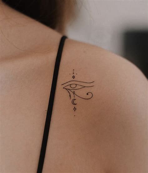 A Woman With A Tattoo On Her Shoulder