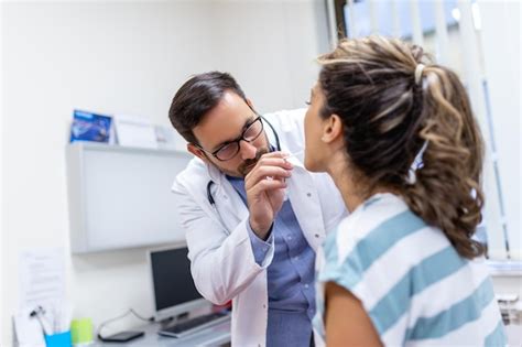 Premium Photo Doctor Using Inspection Spatula To Examine Patient