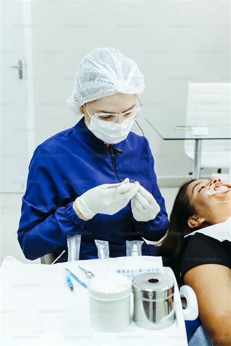 A Woman Getting Her Teeth Checked By A Dentist Photo Dental Check Up Image On Unsplash