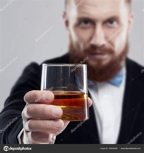 Man Holding A Glass Of Whiskey Stock Photo By Eugenepartyzan