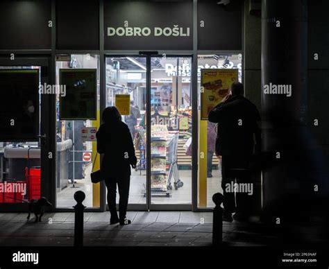 Picture Of A Supermarket With Its Doors And People Waiting In Front Of