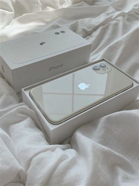 An Iphone Box Sitting On Top Of A Bed Next To It S Open Lid