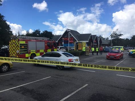 Woman flown to hospital with serious leg injuries after being trapped under car in Tesco car ...