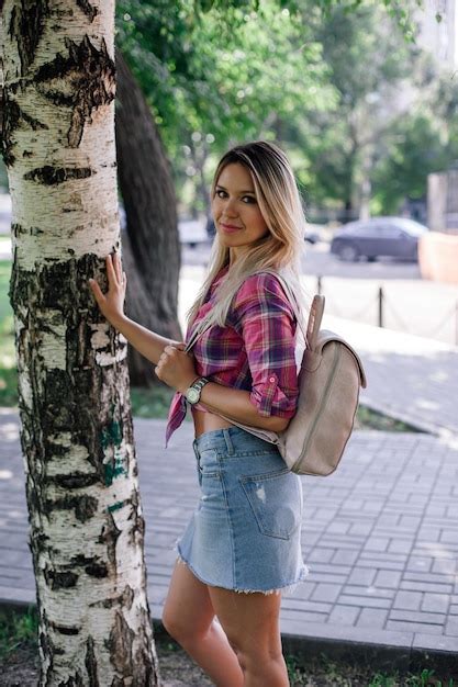 Premium Photo Adult Shining Blonde Woman With Face Looking Into Camera Standing In Park Near