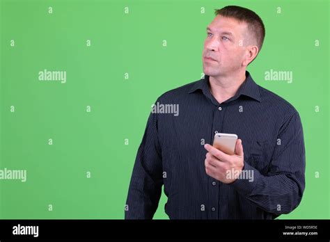 Mature Macho Businessman Thinking While Using Phone Stock Photo Alamy