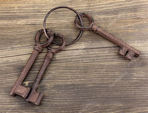 A Bunch Of Antique Keys On Wooden Background — Stock Photo © Belchonock