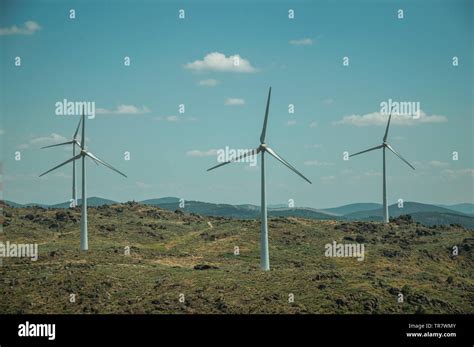 Wind Turbines For Electric Power Generation Over Hilly Landscape At