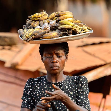 Unidentified Ghanaian Woman Carries A Basin On Her Head In The