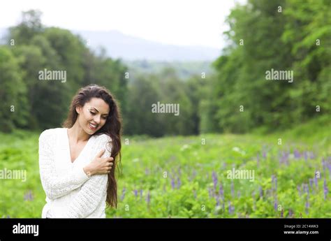 Happy Pretty Brunette Woman In Flower Field Stock Photo Alamy