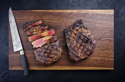 Barbecue Dry Aged Wagyu Rib Eye Beef Steaks On A Wooden Design Board