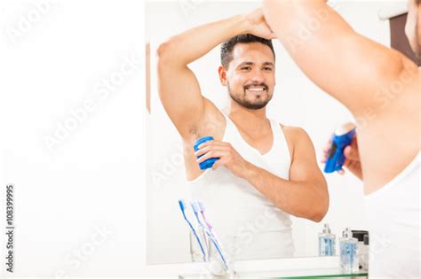 Handsome Guy Putting On Some Deodorant Buy This Stock Photo And