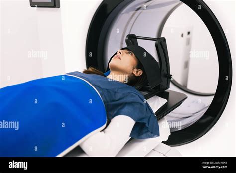 A Female Patient Lies In A Medical Scanner During A Magnetic Resonance