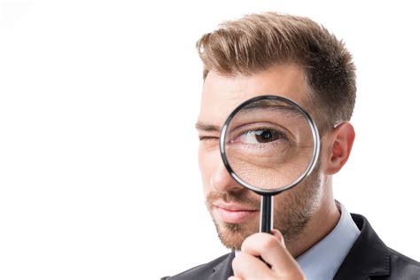 Man Holding Magnifying Glass To Eye Boomer Money And More