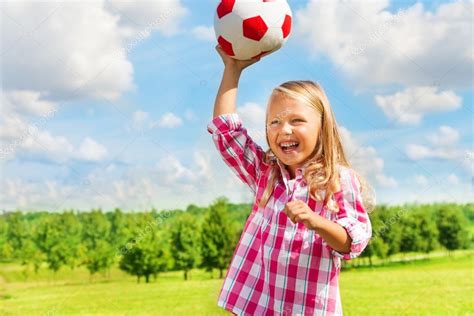 Laughing girl throwing ball Stock Photo by ©serrnovik 36201071