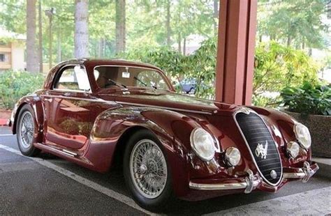 An Old Red Car Is Parked In The Parking Lot