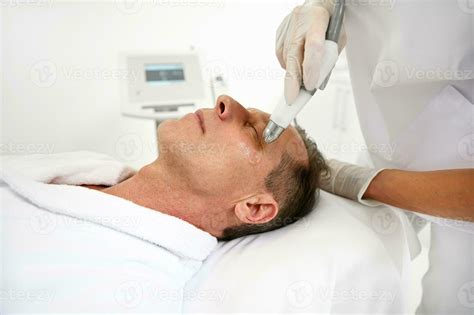 Rejuvenating Facial Therapy Side View Of Mature Caucasian Man Getting