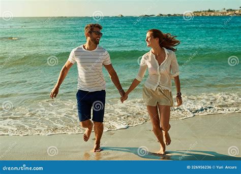 Happy Couple And Holding Hands On Beach For Love Commitment And