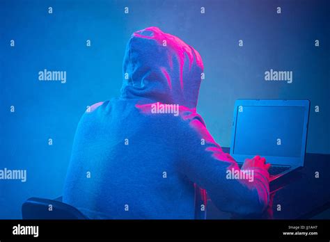 Hooded Computer Hacker Stealing Information With Laptop Stock Photo Alamy