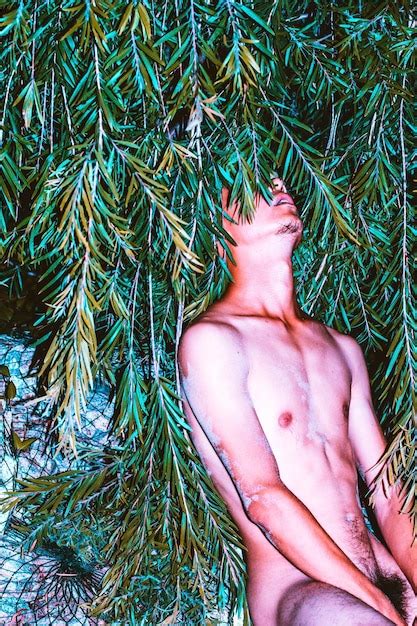 Premium Photo Naked Man Sitting Against Tree