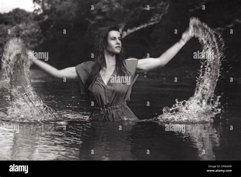 Woman Splashing Water Out Of River Stock Photo Alamy