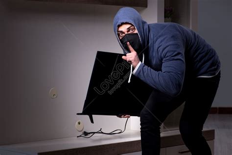 Photo Of Burglar Thief Stealing Tv From Apartment House Picture And Hd