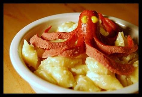 A Bowl Filled With Macaroni And Cheese Covered In An Octopus Like Toppings