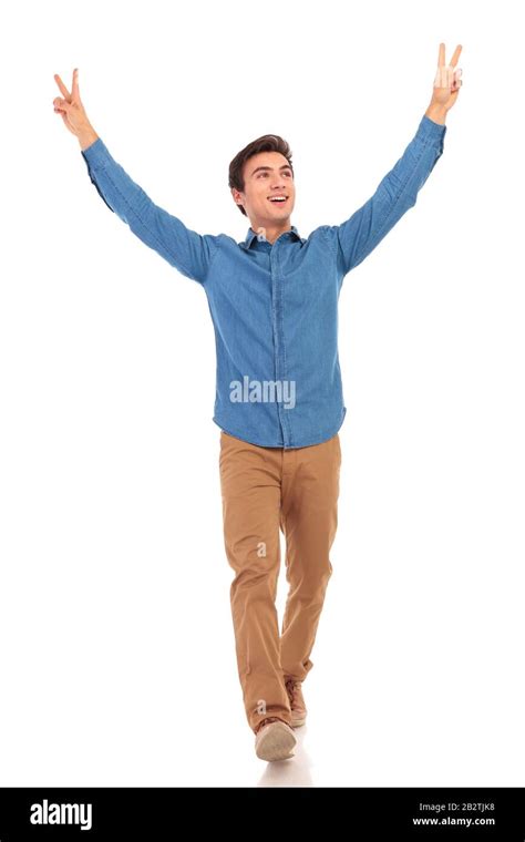 Casual Man Walking With Hands Up In The Air And Looks To Side Making