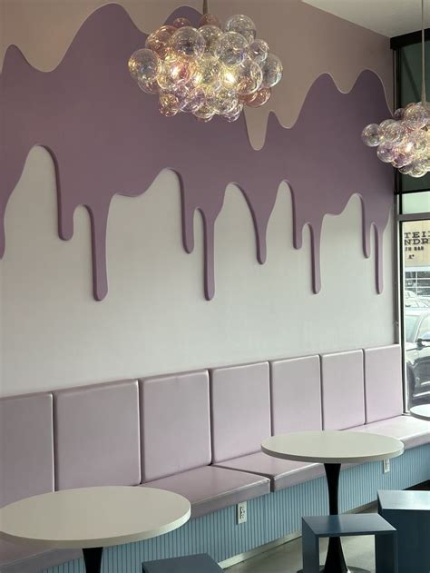 The Purple And White Wall Is Painted With Ice Cream Dripping Down It S