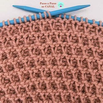 The Crochet Stitch Is Being Worked On By A Pair Of Blue Handled Scissors