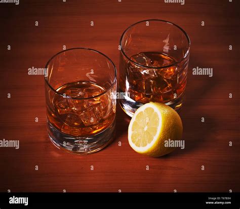 Highball Whiskey Glass With Ice And Lemon Stock Photo Alamy