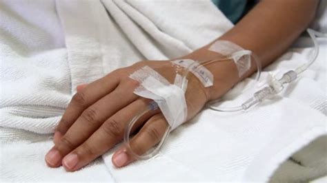 Closeup Saline Drip Into Patient Hand On Bed In Hospital Stock Video