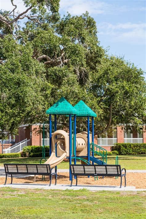 Benches by Colorful Playground Stock Photo - Image of green, slide: 49581196