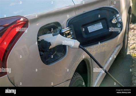 Hybrid Electric Car With Electricity Charging Cable Close Up Of Plug