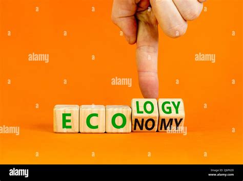 Ecology Or Economy Symbol Businessman Turns Wooden Cubes And Changes