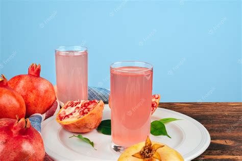 Premium Photo Glass Of Pomegranate Juice And Fruits On A Table