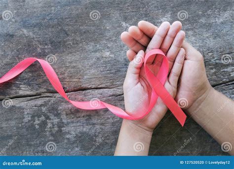 Hand Holding Pink Ribbon On Wood Breast Cancer Awareness Conc Stock