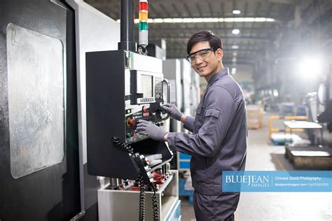 Confident Chinese Engineer Working In The Factory High Res Stock Photo