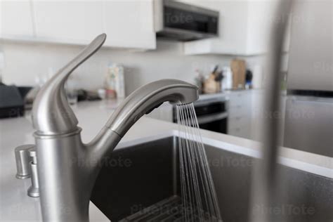 Faucet With Running Water In Stock Photo Pixeltote