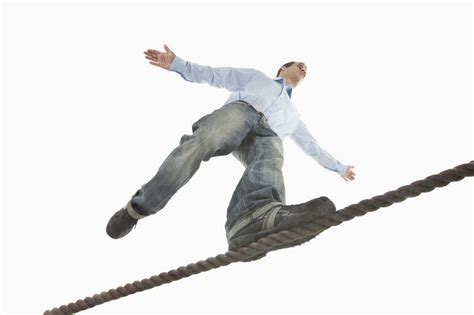 Young Man Balancing On Tightrope Stock Photo