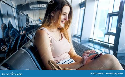 Closeup Portrait Of Beautiful Blonde Woman Sitting In Airport Waiting