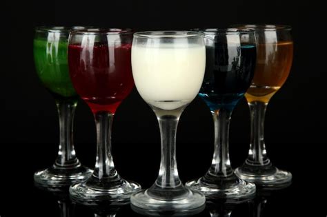 Premium Photo | Tasty color liquors isolated on black