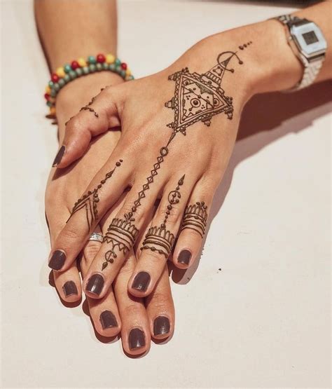 A Woman S Hands With Tattoos On Them