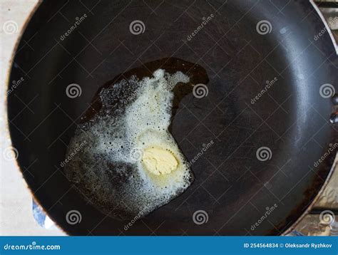 Butter Pat Melting on a Black Cast Iron Frying Pan Stock Photo - Image ...