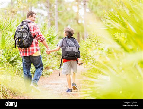 Father And His Son Walking Together Holding Hands Hi Res Stock